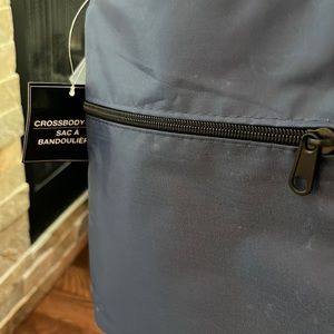 Crossbody bag 9.25” long 23.5cm long/19.5 cm wide navy blue one zipper bag.